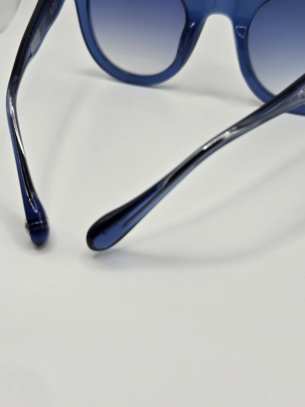 Aperçu sunglasses featuring a bold acetate frame and gold tone branding